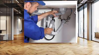 Professional plumber fixing piping system at home Wall mural