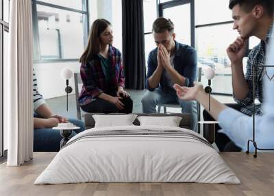 Psychotherapist working with patients in group therapy session indoors Wall mural