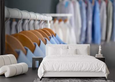 Rack with clean clothes on hangers after dry-cleaning indoors Wall mural