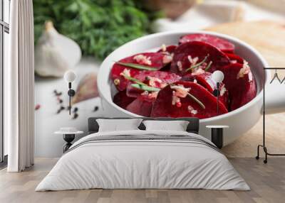 Raw beetroot slices, garlic and rosemary in bowl on white table, closeup Wall mural