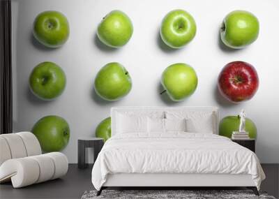 Red apple among green ones on white background, top view Wall mural