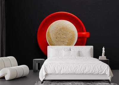 Red cup with aromatic cappuccino on black background, top view Wall mural