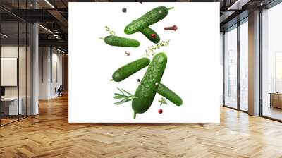 Ripe cucumbers, herbs and spices falling on white background Wall mural