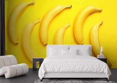 Ripe tasty bananas on yellow background, flat lay Wall mural