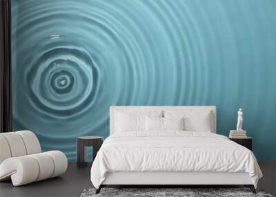 Rippled surface of clear water on light blue background, top view Wall mural