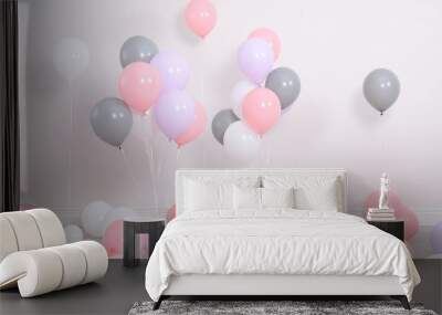 Room decorated with colorful balloons near wall Wall mural