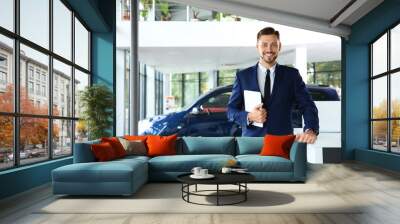 Salesman with tablet in modern car dealership Wall mural