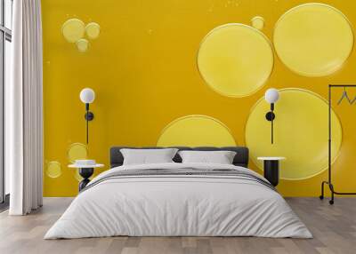 Sample of cosmetic oil on dark yellow background, macro view Wall mural