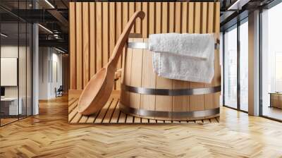 Sauna equipment. Bucket, towel and ladle on wooden surface Wall mural