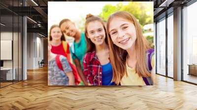 School holidays. Group of happy children taking selfie outdoors Wall mural