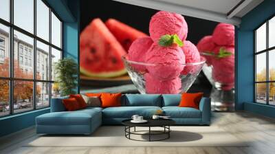 Scoops of tasty watermelon sorbet with mint in glass dessert bowls on black table, closeup Wall mural