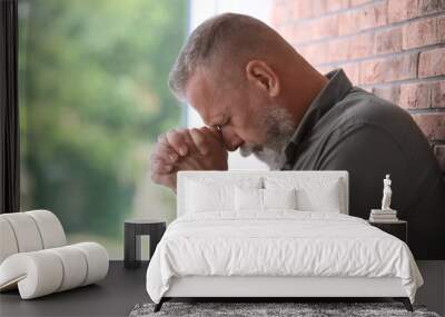 Senior man in state of depression near brick wall Wall mural