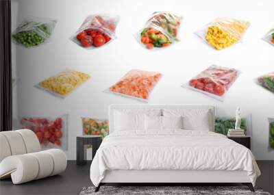 Set of different frozen vegetables in plastic bags on white background Wall mural