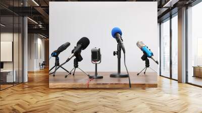 Set of different microphones on wooden table. Journalist's equipment Wall mural