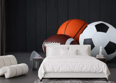 set of different sport balls and shuttlecock on grey wooden table Wall mural