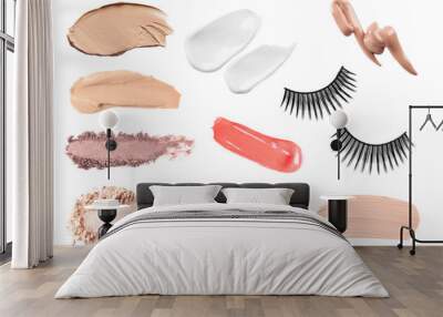 Set with swatches of lipsticks, eye shadows, skin foundations and false eyelashes on white background, top view Wall mural