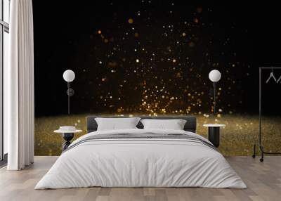 Shiny golden glitter falling down on black background. Bokeh effect Wall mural