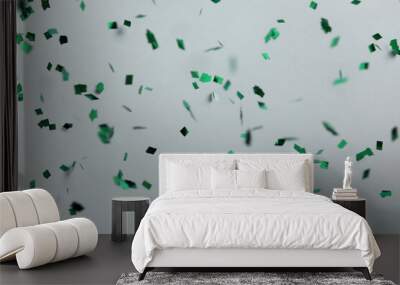 Shiny green confetti falling down on light grey background Wall mural