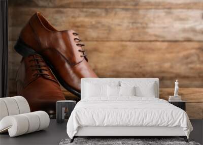 Shoe care products and footwear on wooden table. Space for text Wall mural