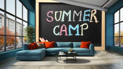 Small blackboard with text SUMMER CAMP and chalk sticks, flat lay Wall mural