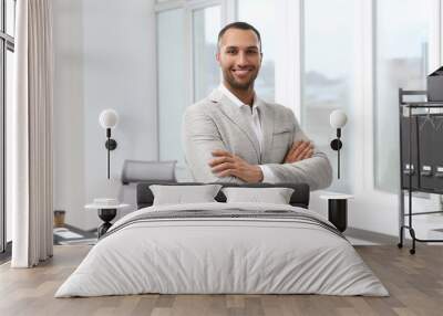 Smiling young businessman in his modern office Wall mural