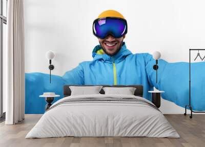 Smiling young man in ski goggles taking selfie on white background Wall mural