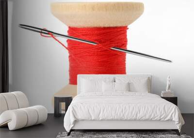 Spool of red sewing thread with needle isolated on white Wall mural