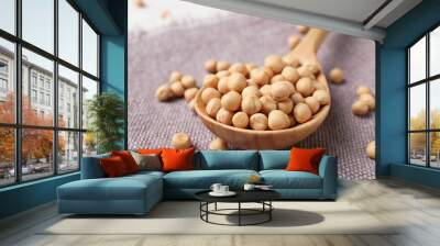 Spoon with dried peas on cloth, closeup Wall mural