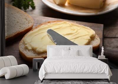 Spreading butter onto toast with knife on wooden board Wall mural