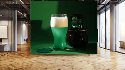 St. Patrick's day party. Green beer, leprechaun hat, pot of gold and decorative clover leaves on green background Wall mural