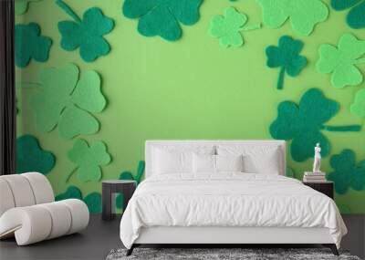 St. Patrick's day. Frame of decorative clover leaves on green background, flat lay. Space for text Wall mural