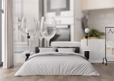 Stack of clean dishes, glasses and cups on table in kitchen Wall mural