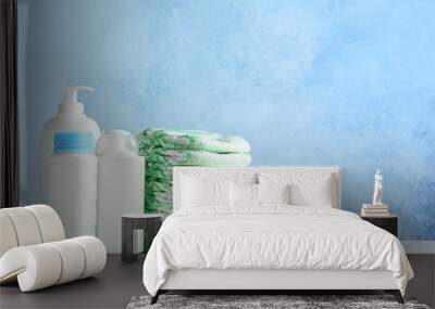 Stack of diapers and toiletries on table against color background, space for text. Baby accessories Wall mural