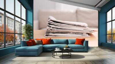 Stack of newspapers in different languages on table indoors Wall mural