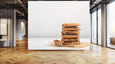 Stack of tasty chocolate cookies on light table Wall mural