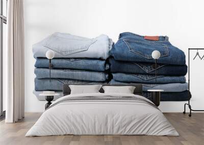 Stacks of different folded jeans isolated on white Wall mural