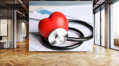 Stethoscope, red heart and cardiogram on table. Cardiology concept Wall mural