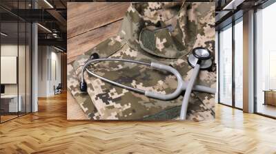 Stethoscope and military uniform on wooden table Wall mural