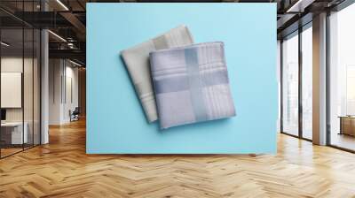 Stylish handkerchiefs on light blue background, flat lay Wall mural