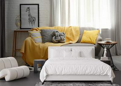 Stylish living room interior with soft pillows and yellow plaid on sofa Wall mural