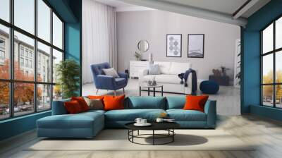 Stylish living room interior with white sofa, armchair and small coffee table Wall mural