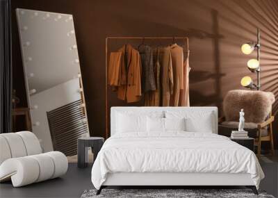 Stylish mirror with light bulbs and comfortable armchair in dressing room. Interior design Wall mural