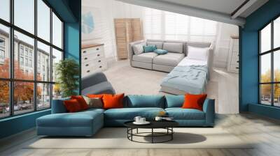 Stylish room interior with sleeper sofa and rocking chair. Additional place for guest Wall mural