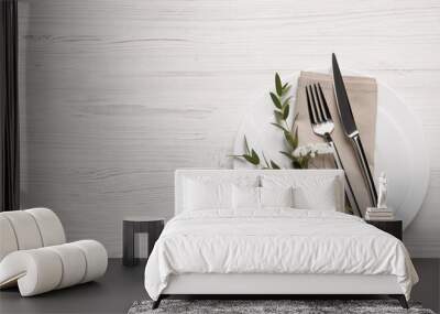 Stylish setting with cutlery and eucalyptus leaves on white wooden table, flat lay. Space for text Wall mural