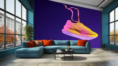 Stylish sneaker in air against dark purple background in neon lights, space for text Wall mural