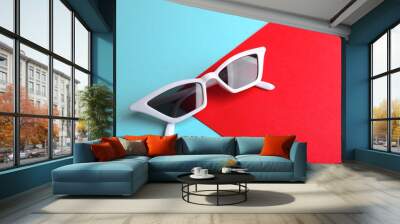 Stylish sunglasses on color background, above view with space for text. Summer time Wall mural