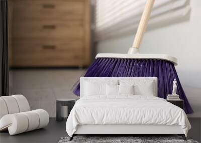 Sweeping wooden floor with bright broom indoors Wall mural