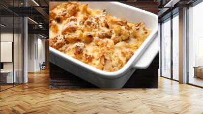 Tasty baked cauliflower in baking dish on wooden table, closeup Wall mural