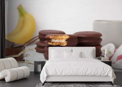 Tasty banana choco pies on white table, closeup Wall mural