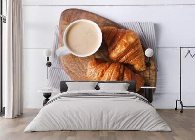 Tasty breakfast. Cup of coffee and croissants on white wooden table, top view Wall mural